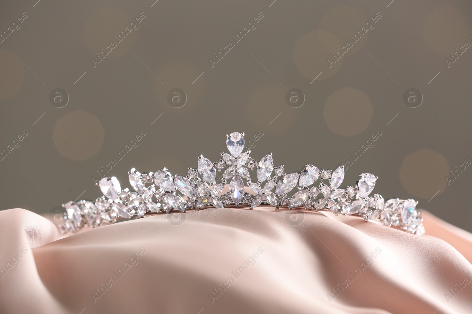 Photo of Beautiful silver tiara with diamonds on light cloth