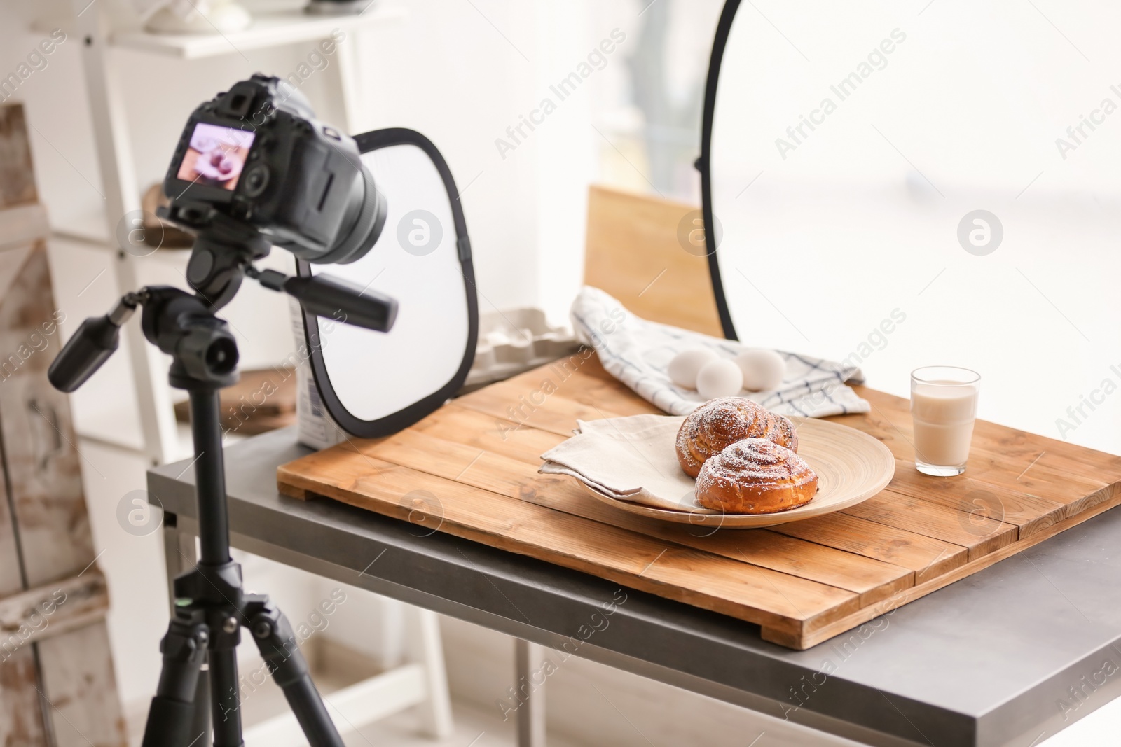 Photo of Professional camera on tripod and food composition in photo studio