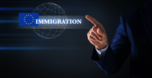 Image of Immigration. Businessman touching digital screen with globe, word and flag of Europe on black background, closeup