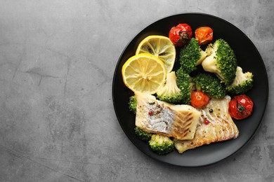 Photo of Tasty cod cooked with vegetables on grey table, top view. Space for text