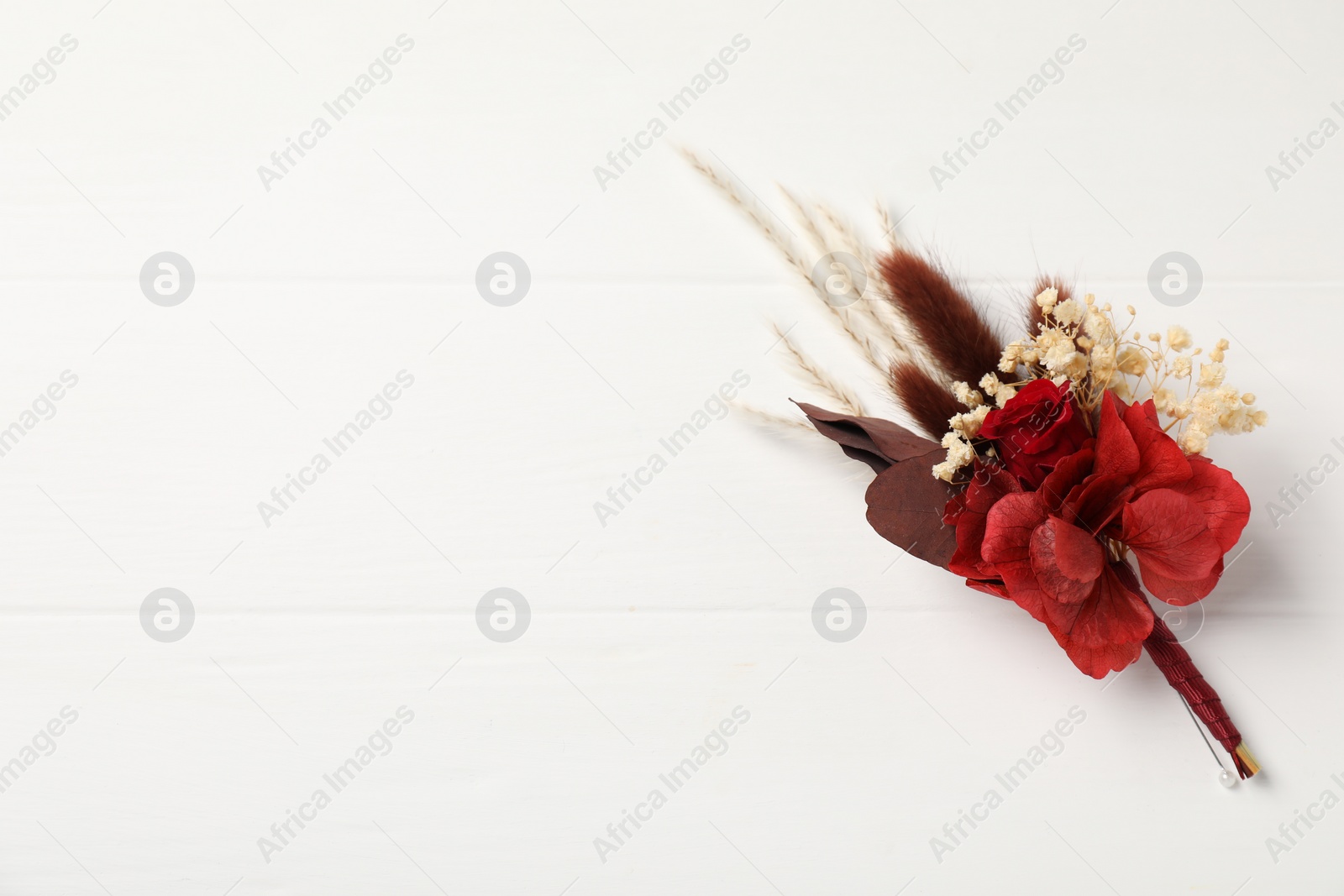 Photo of Beautiful boutonniere on white background, top view. Space for text