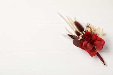 Beautiful boutonniere on white background, top view. Space for text