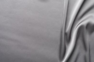 Photo of Texture of beautiful light grey silk fabric as background, closeup