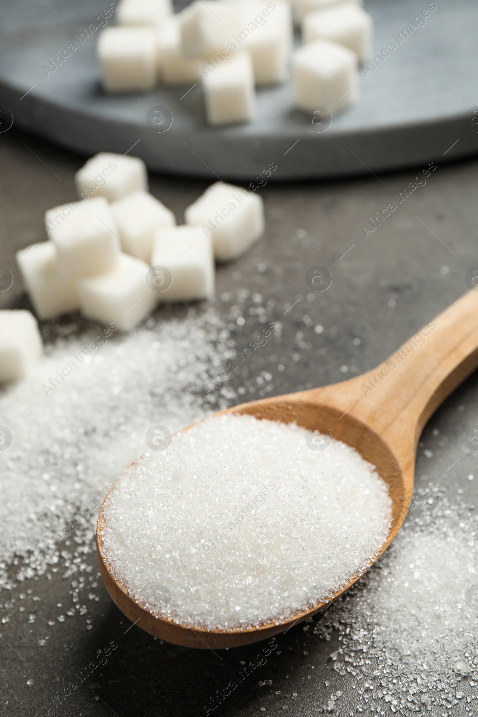 Photo of Composition with granulated sugar on grey table