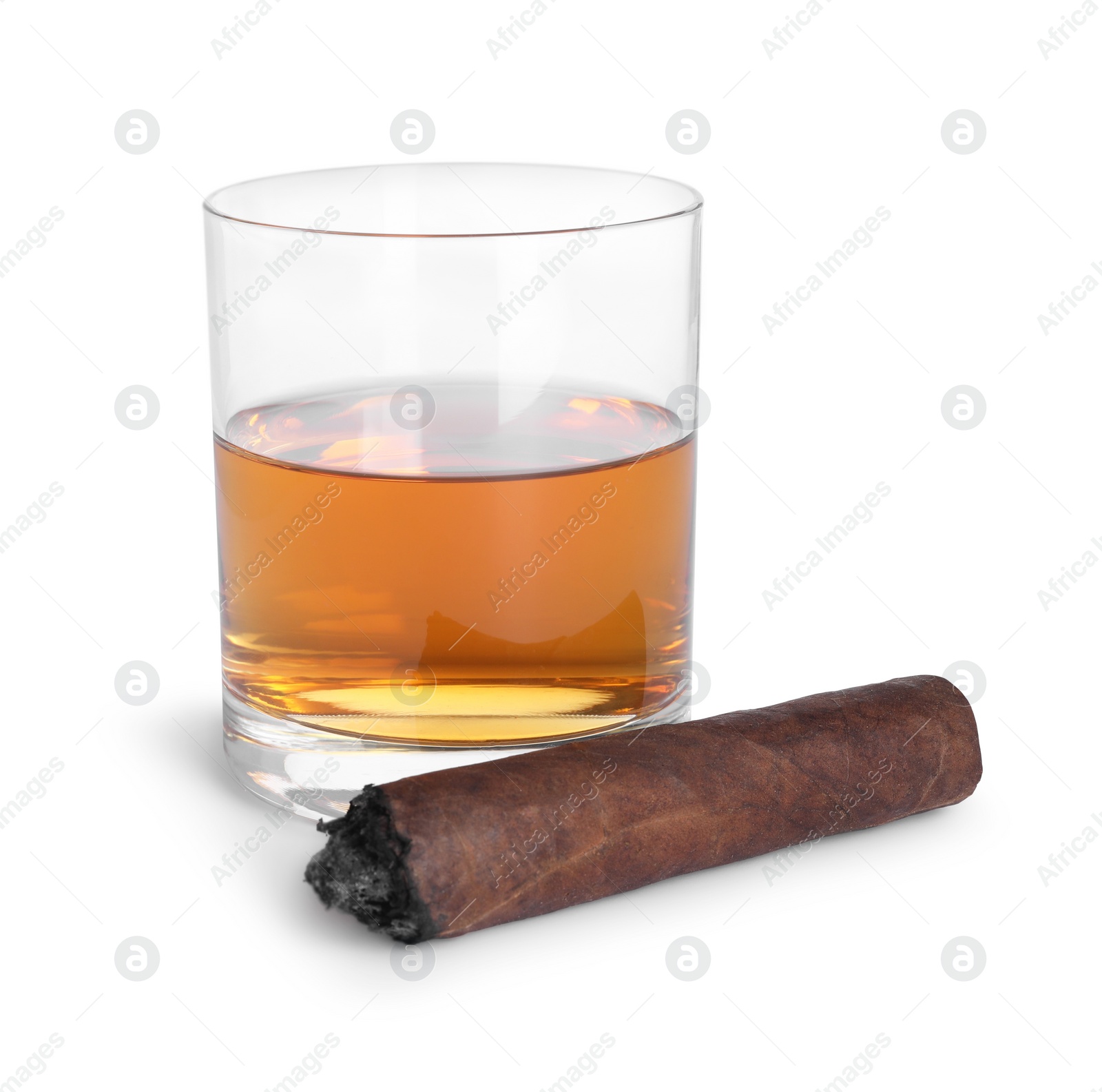 Photo of Glass of whiskey and burnt cigar isolated on white