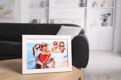 Photo of Frame with family photo on wooden coffee table in room, space for text