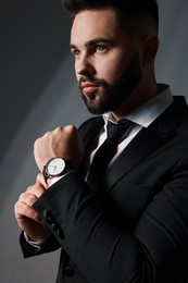 Photo of Handsome bearded man in stylish suit on grey background