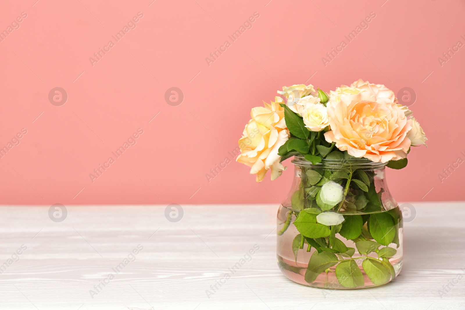 Photo of Vase with blooming flowers on table indoors