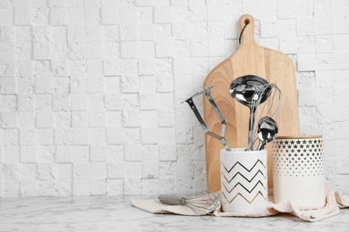 Photo of Clean kitchen utensils and board on table. Space for text