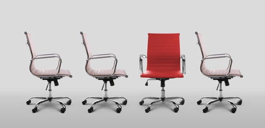 Image of Vacant position. Red office chair among another ones on light grey background, banner design