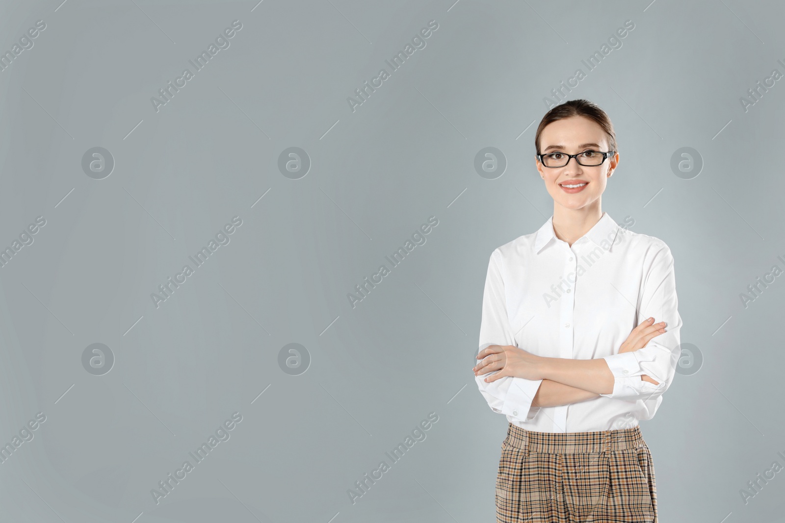 Photo of Portrait of young female teacher on grey background. Space for text