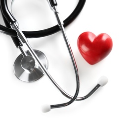 Photo of Stethoscope and small red heart on light background. Heart attack concept