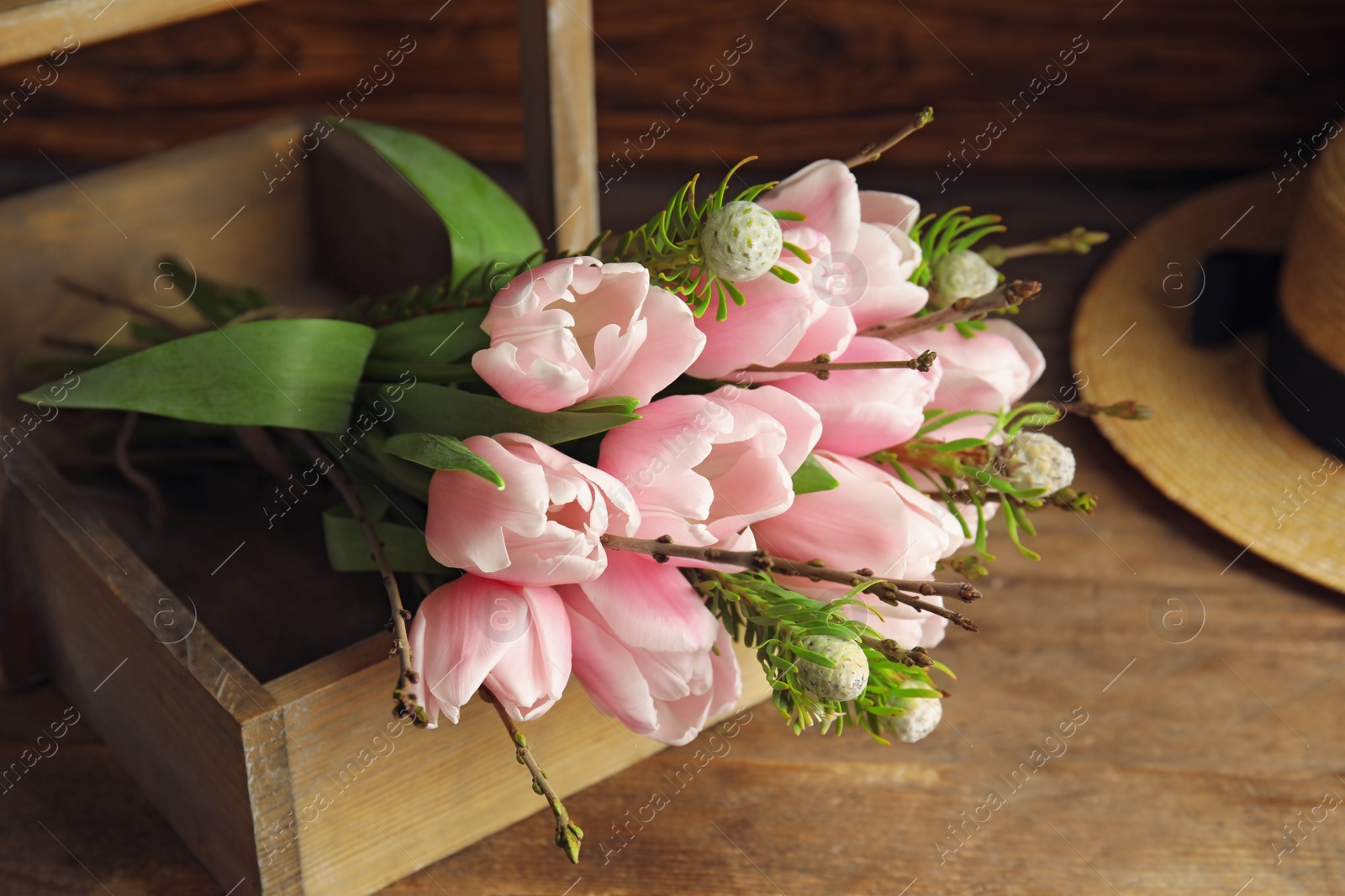 Photo of Beautiful bouquet of spring pink tulips on wooden table