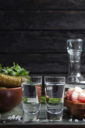 Photo of Cold Russian vodka with snacks on table