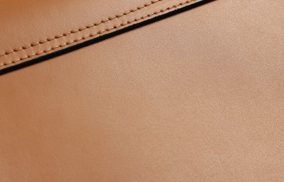 Photo of Brown natural leather with seams as background, closeup