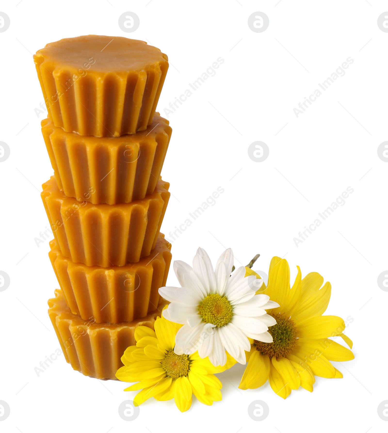 Photo of Stack of natural beeswax cake blocks and flowers on white background