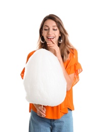 Happy young woman with cotton candy on white background