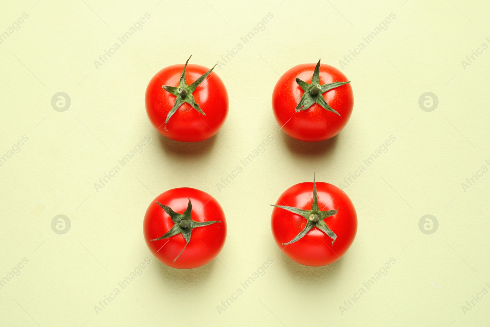 Photo of Flat lay composition with ripe cherry tomatoes on color background