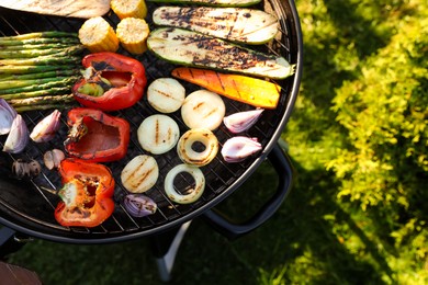 Delicious grilled vegetables on barbecue grill outdoors, top view