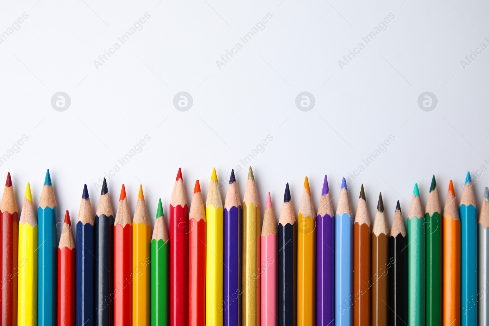 Photo of Composition with color pencils on white background, top view