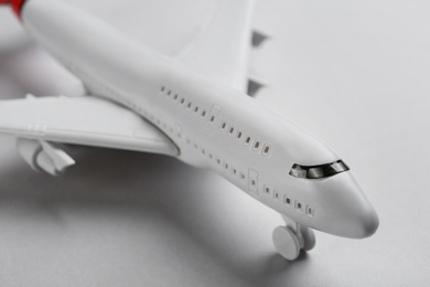 Toy airplane on light background, closeup view