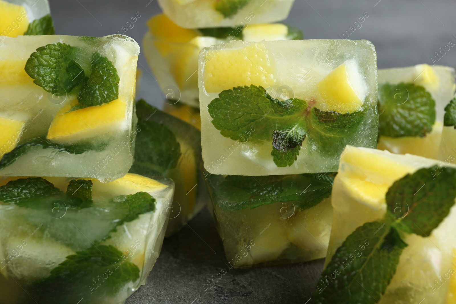 Photo of Ice cubes with mint and lemon, closeup