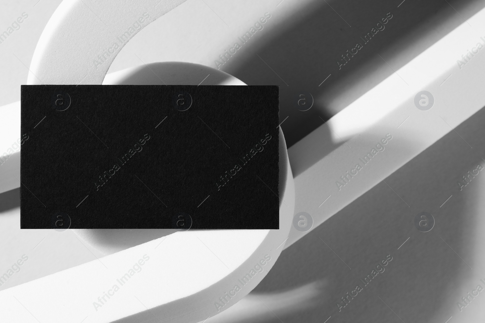 Photo of Empty black business card and decorative elements on white background. Mockup for design