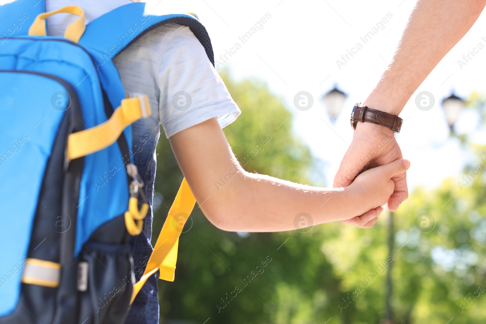 Photo of Young father taking his child to school