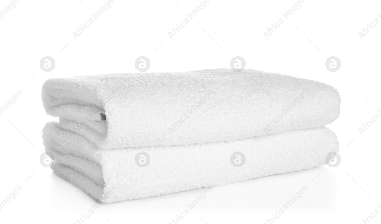 Photo of Stack of clean soft towels on white background