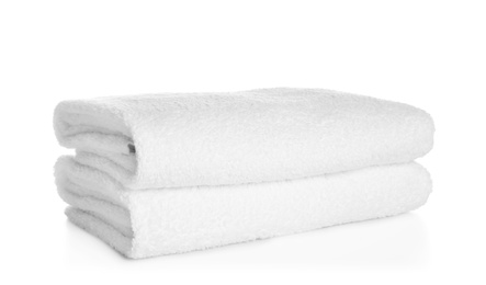 Photo of Stack of clean soft towels on white background