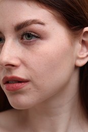 Photo of Portrait of beautiful woman with freckles, closeup