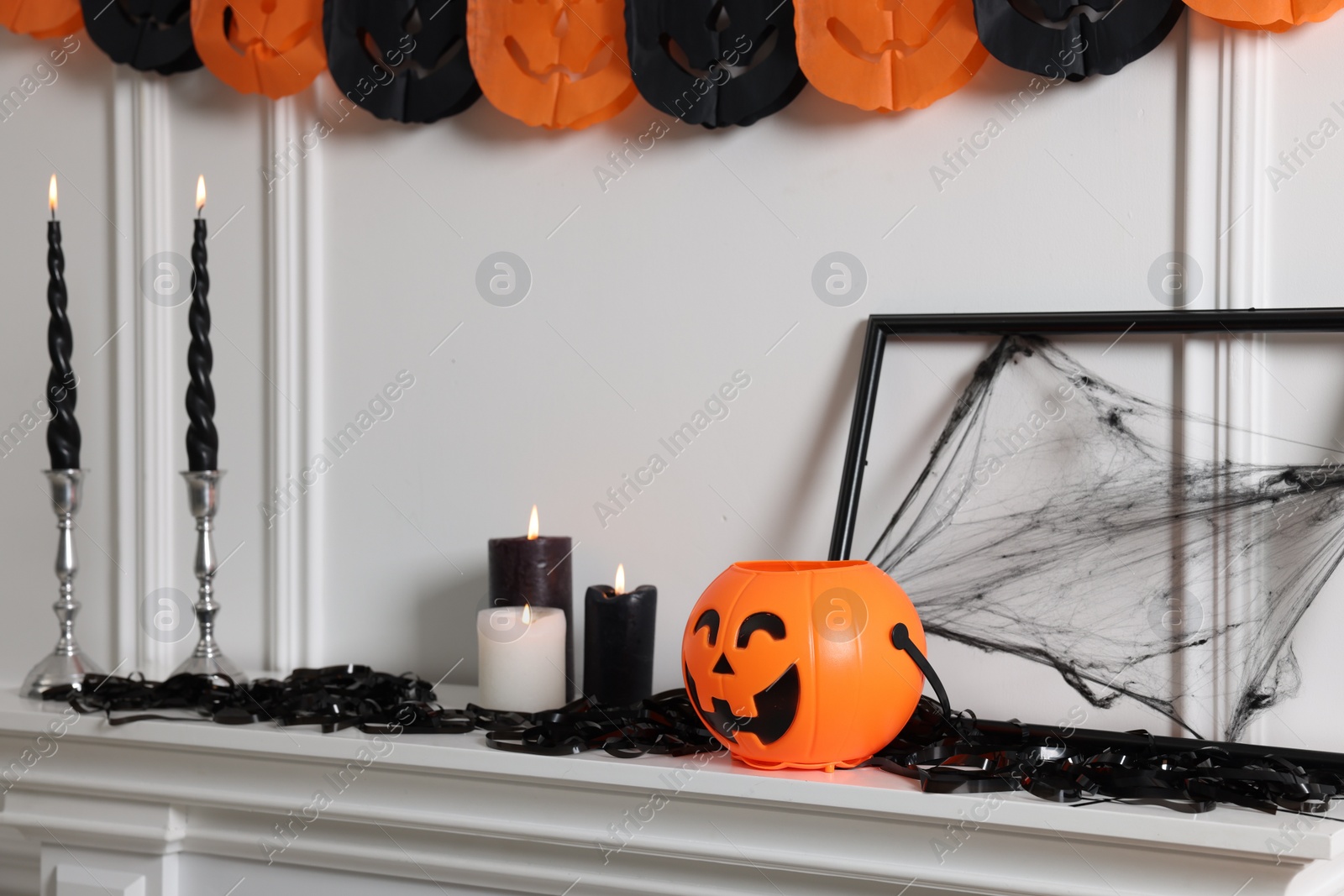 Photo of Different Halloween decor near white wall indoors