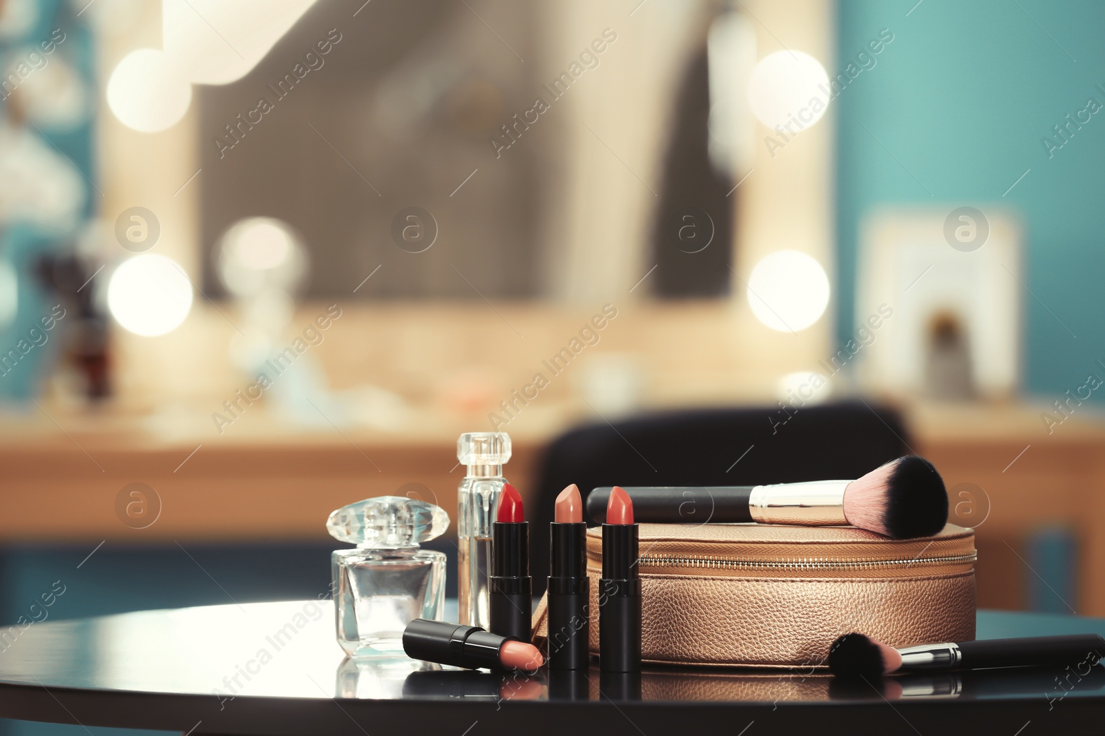 Photo of Decorative cosmetics and tools on dressing table in makeup room, closeup