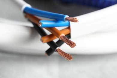 Photo of Colorful electrical wires on blurred background, closeup