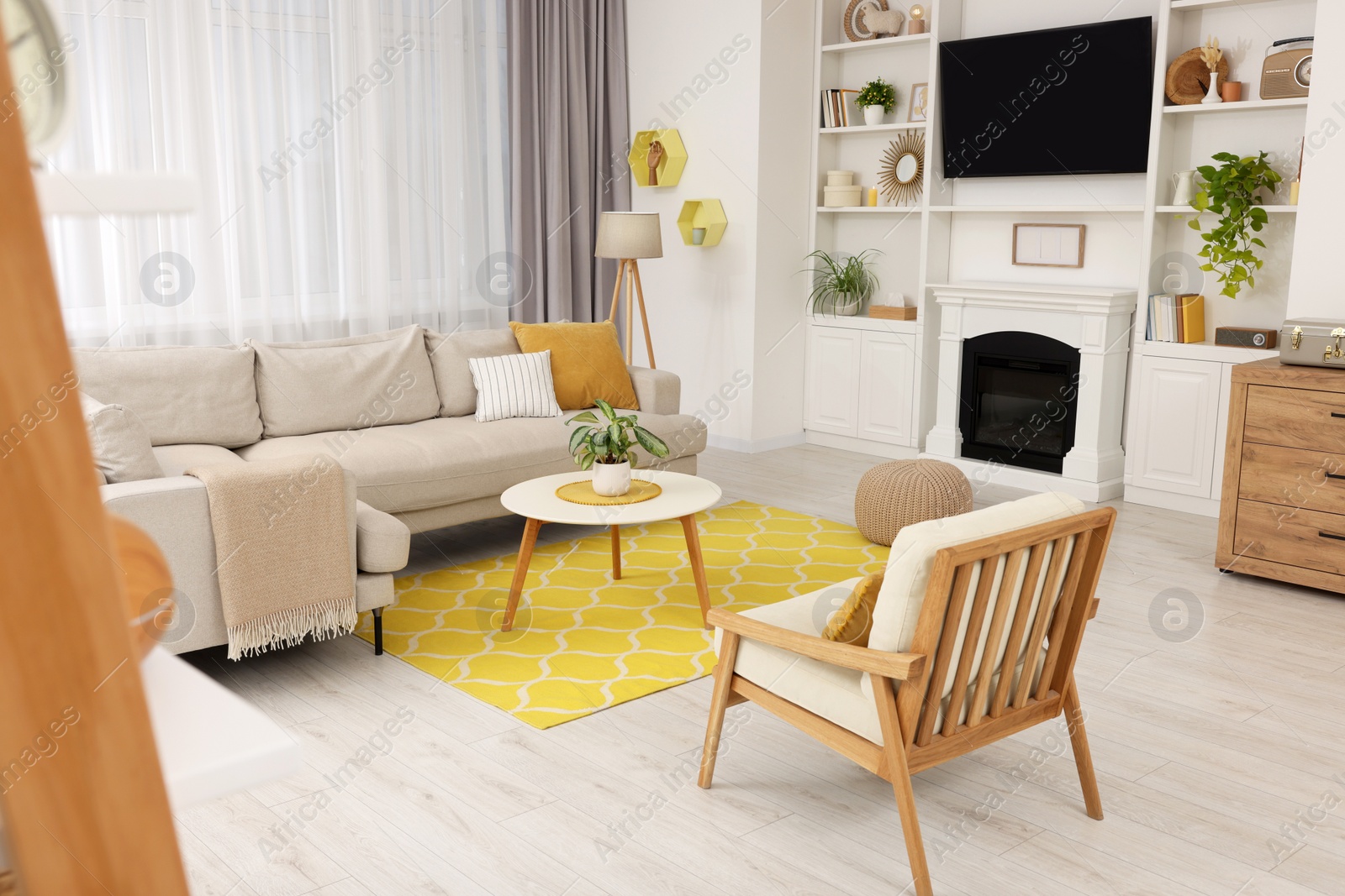 Photo of Spring atmosphere. Stylish room interior with cozy furniture in yellow and white colors