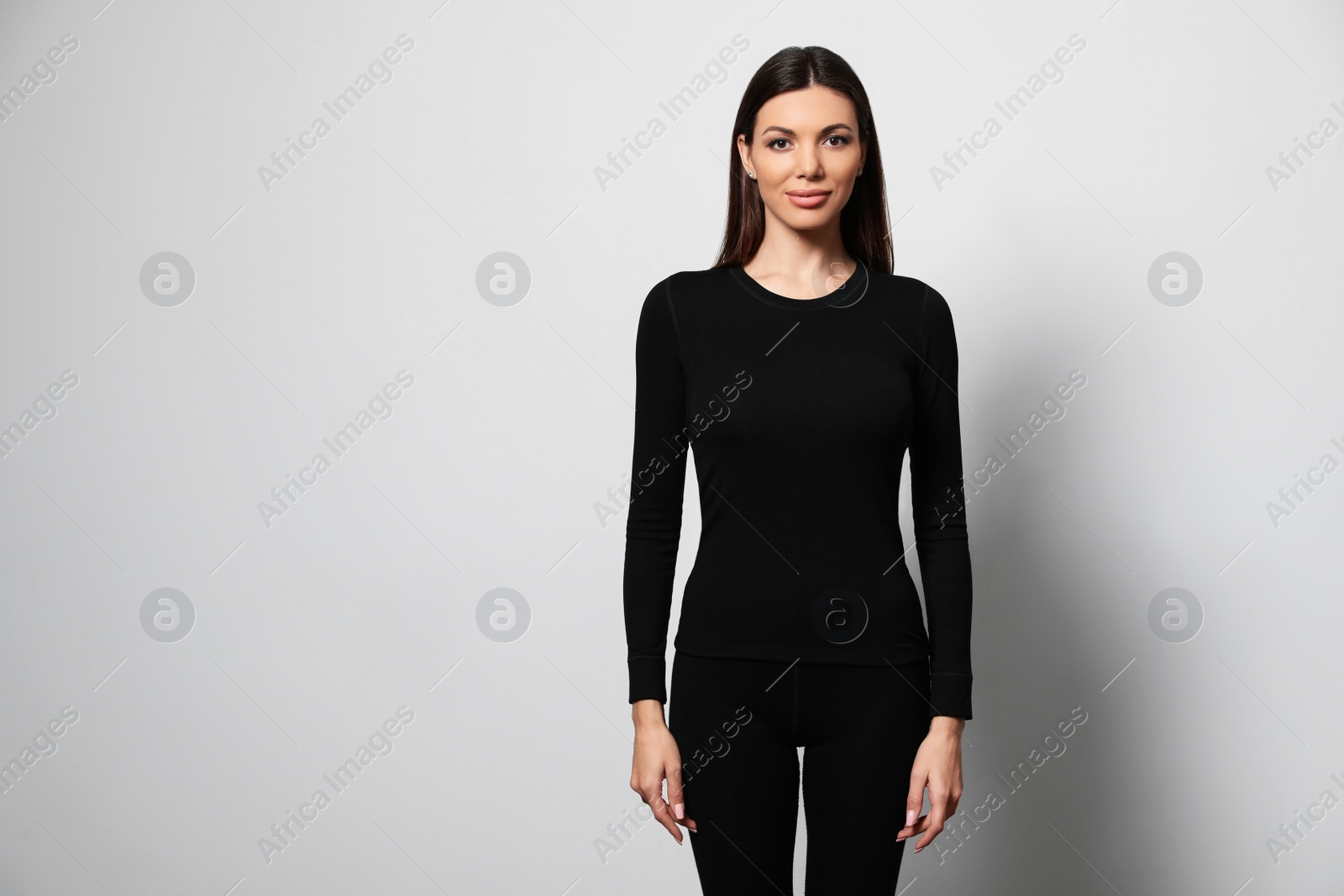 Photo of Woman wearing thermal underwear on light grey background. Space for text