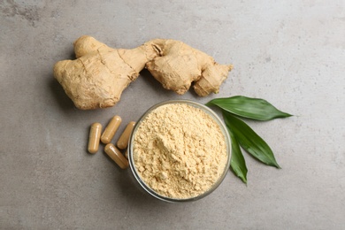 Photo of Dry, fresh and capsuled ginger on grey table, flat lay