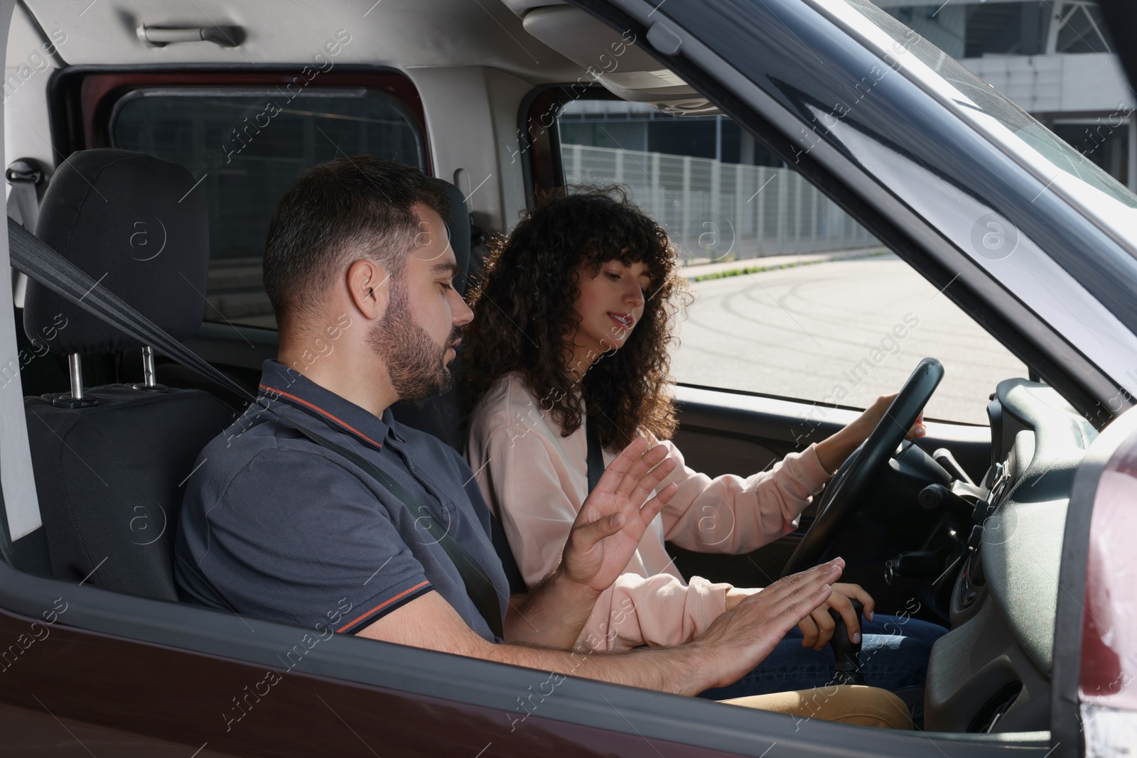 Photo of Driving school. Student during lesson with driving instructor in car