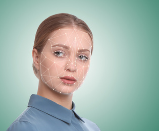 Facial recognition system. Young woman with biometric identification scanning grid on light green background