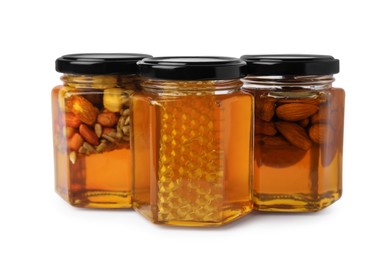 Photo of Jars with different nuts and honey on white background