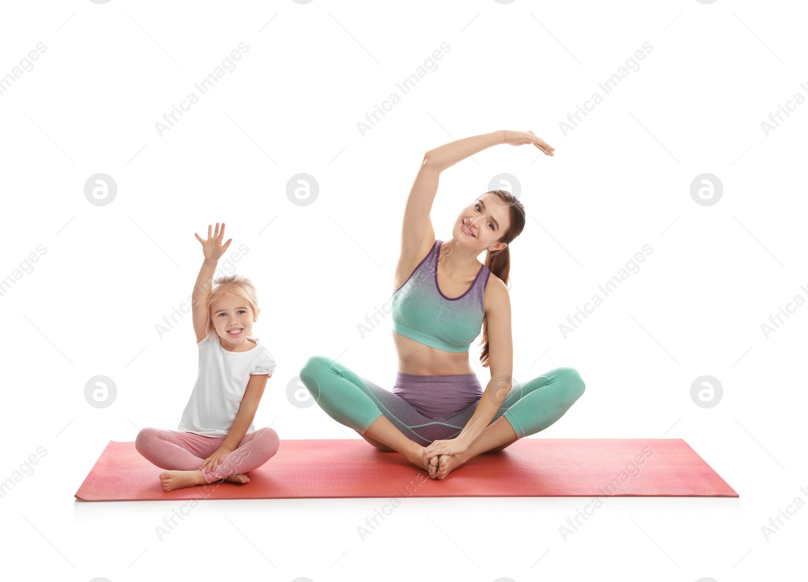 Photo of Young woman and her daughter doing exercise isolated on white. Home fitness