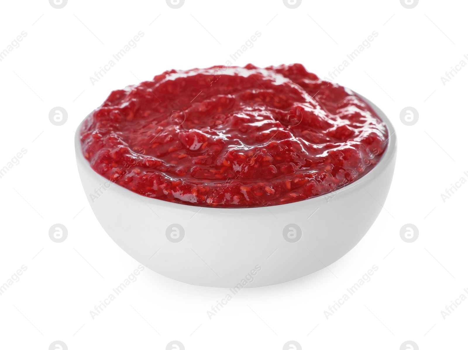 Photo of Raspberry puree in bowl on white background