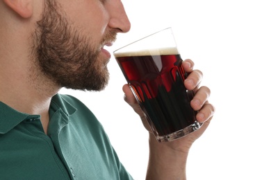 Young man with cold kvass on white background, closeup. Traditional Russian summer drink