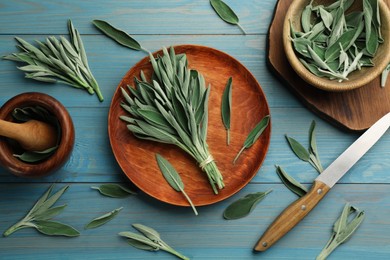 Photo of Fresh green sage with kitchen utensils on turquoise wooden table, flat lay
