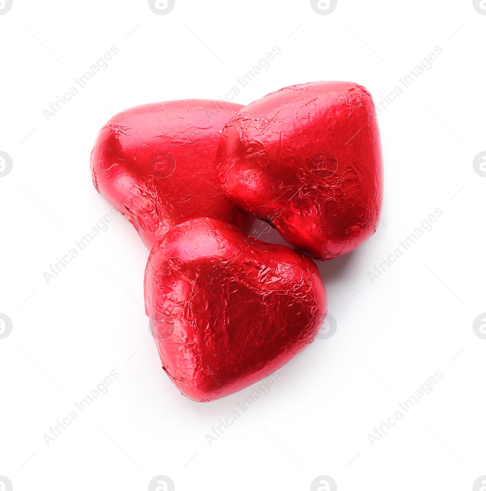 Photo of Heart shaped chocolate candies in red foil on white background, top view