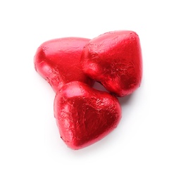 Heart shaped chocolate candies in red foil on white background, top view