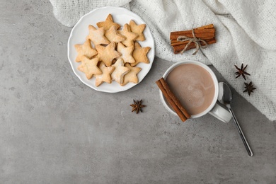Composition with delicious hot cocoa drink and cookies on grey background, flat lay