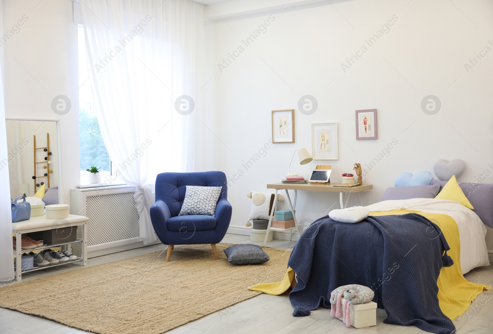 Photo of Modern teenager's room interior with bed and armchair