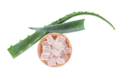 Photo of Peeled aloe vera in bowl and green leaves isolated on white, top view