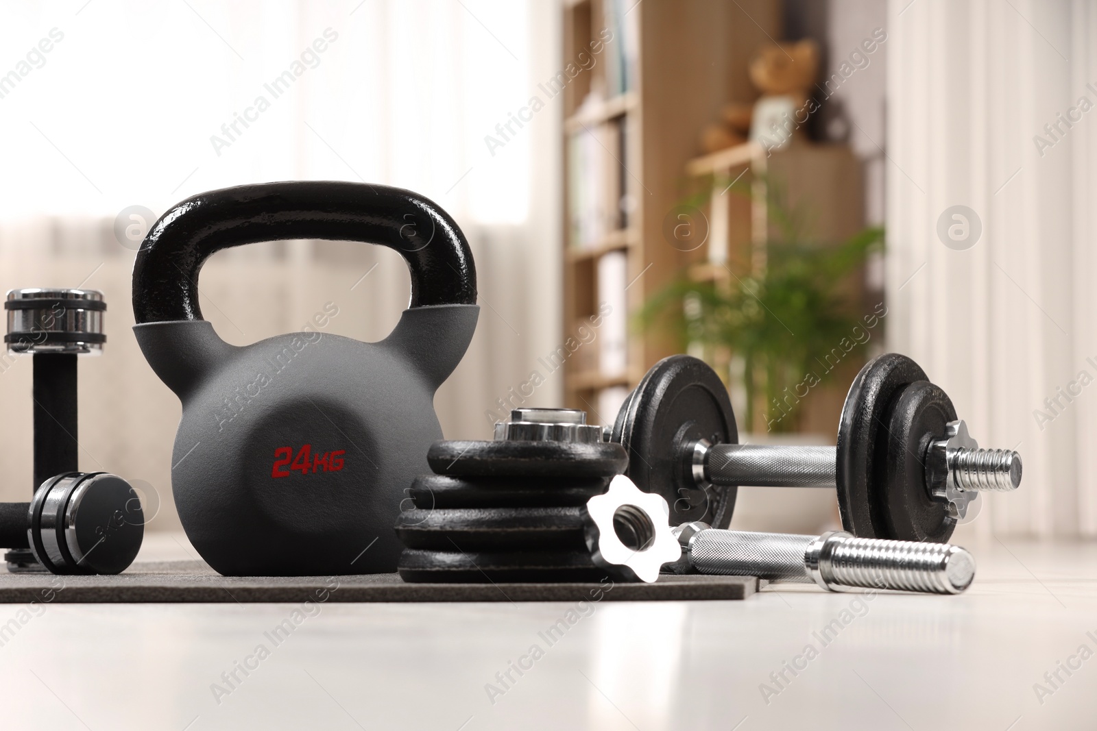 Photo of Many different sports equipment on floor indoors